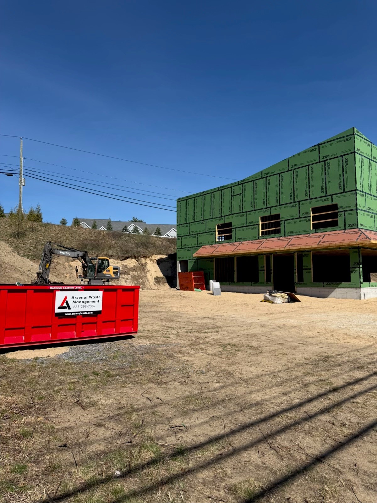 Arsenal Waste Management red roll-off truck servicing Merrimack County New Hampshire