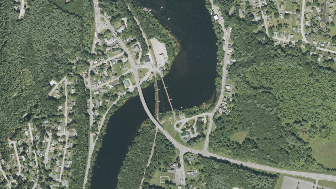 Aerial view of Hooksett village and its bridges across the Merrimack River, New Hampshire