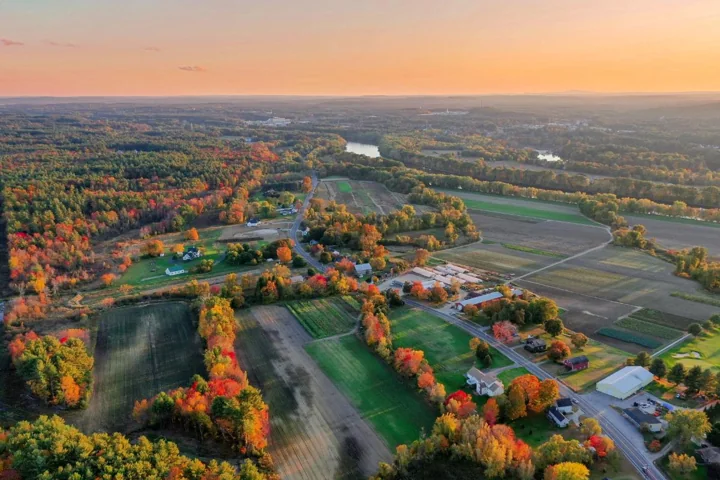 Aerial view of fields and autumn trees in Litchfield, New Hampshire