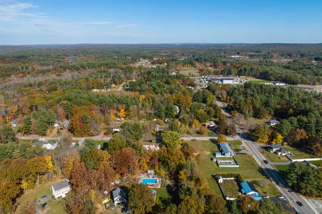 Aerial view of homes and autumn woodland in Pelham, New Hampshire