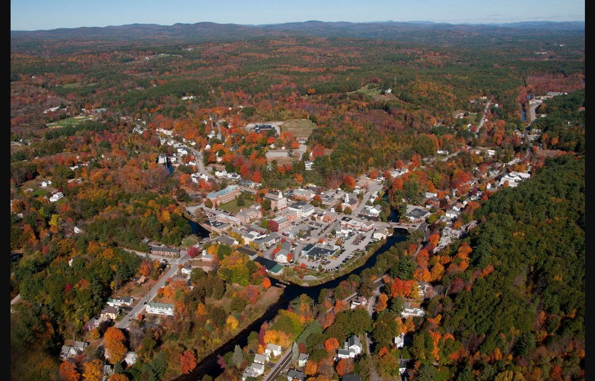 Autumn aerial view of downtown Peterborough, its river and wooded hills in New Hampshire
