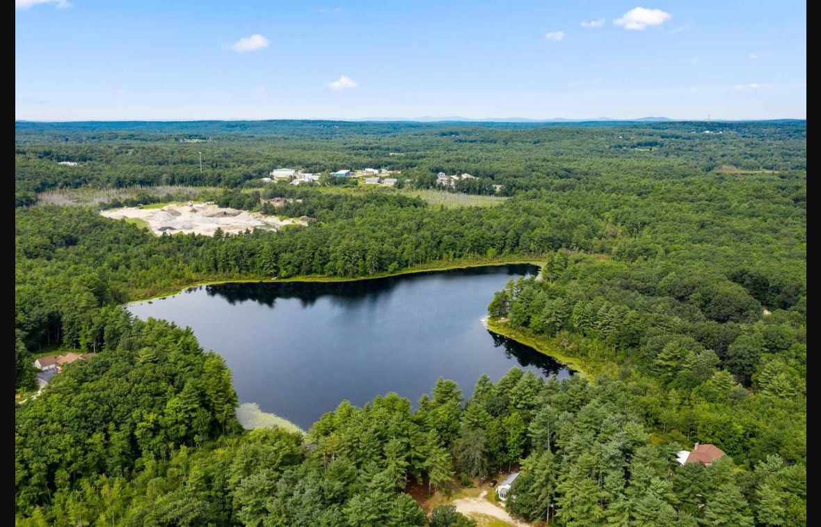 Aerial view of Showell Pond and surrounding forest in Sandown, New Hampshire